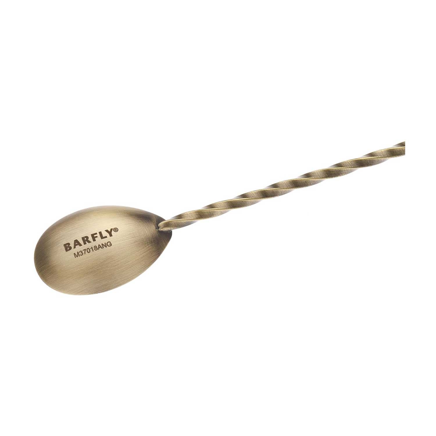 A close-up of an Antique Gold finished Barfly Bar Spoon with Muddler on a white background