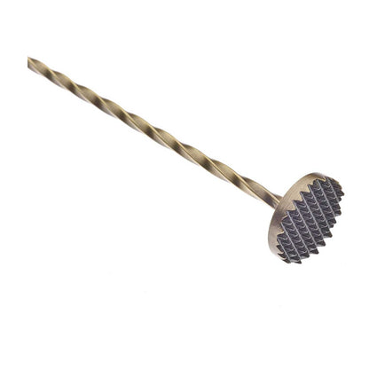 A close-up of an Antique Gold finished Barfly Bar Spoon with Muddler on a white background