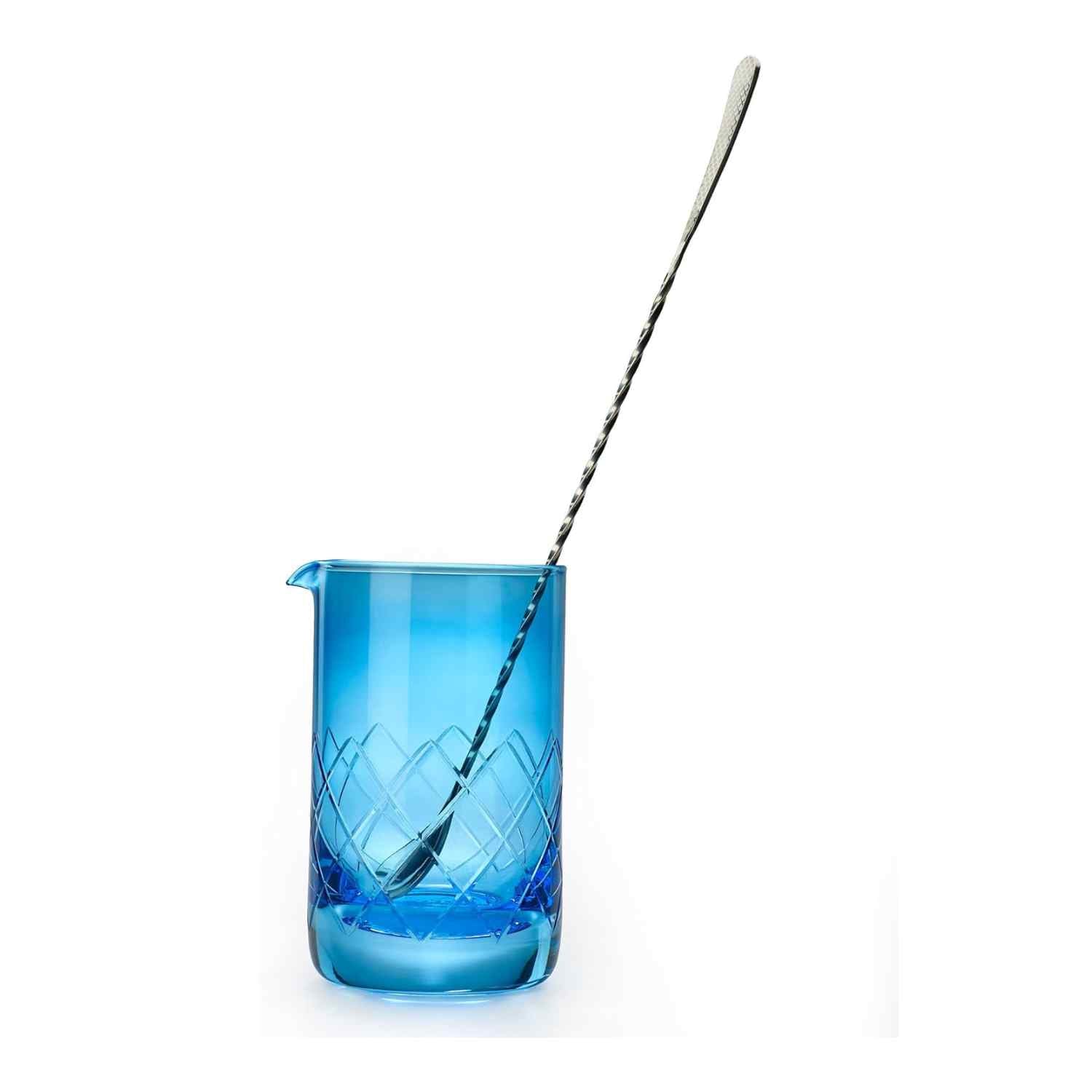 A Blue Barfly Mixing Glass 17oz (500 ml) with geometric patterns with a barspoon on a white background