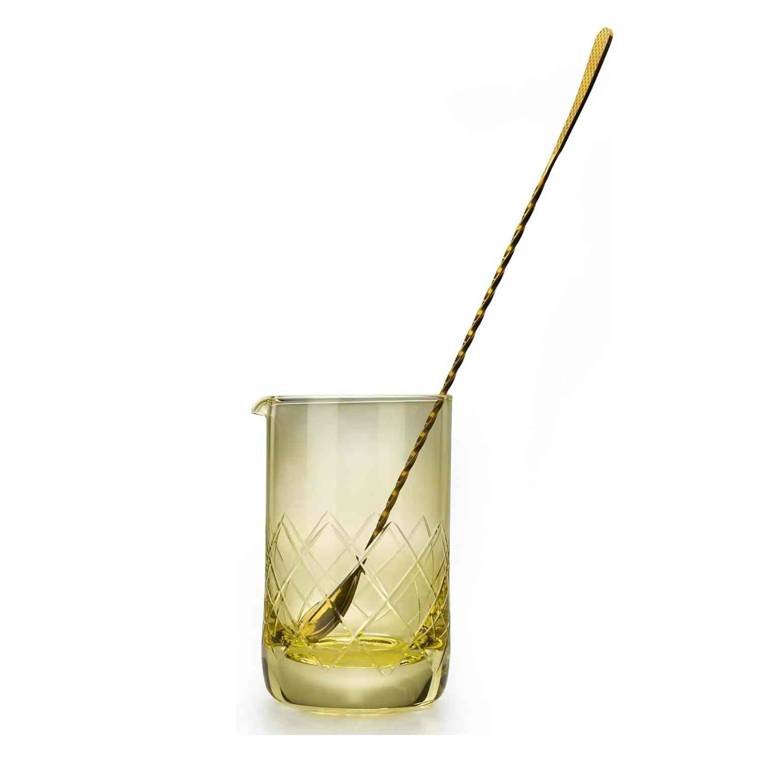 A Gold Barfly Mixing Glass 17oz (500 ml) with geometric patterns with a barspoon on a white background